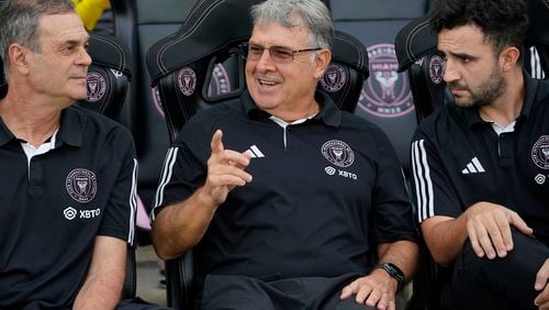 Inter Miami head coach Gerardo "Tata" Martino speaks to members of his staff before the first half of a Leagues Cup soccer match against Atlanta United, Tuesday, July 25, 2023, in Fort Lauderdale, Fla. (AP Photo/Lynne Sladky)
