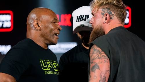 FILE - Mike Tyson, left, and Jake Paul, right, face off during a news conference promoting their upcoming boxing bout, May 16, 2024, in Arlington, Texas. (AP Photo/Sam Hodde, File)