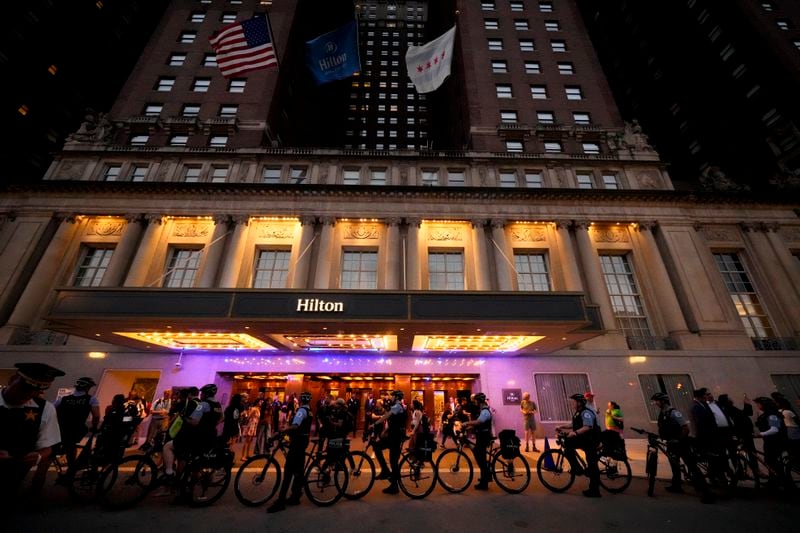 Protesters march passed a police line prior to the start of the Democratic National Convention Sunday, Aug. 18, 2024, in Chicago. (AP Photo/Julio Cortez)