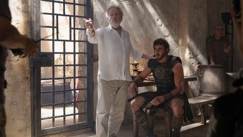 This image released by Paramount Pictures shows director Ridley Scott, center, Paul Mescal on the set of "Gladiator II." (Aidan Monaghan/Paramount Pictures via AP)