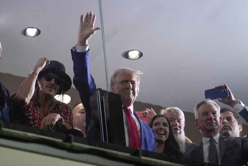 Republican presidential nominee former President Donald Trump waves during the Georgia vs. Alabama football game at Bryant-Denny Stadium, Saturday, Sept. 28, 2024, in Tuscaloosa, Ala. (AP Photo/Evan Vucci)