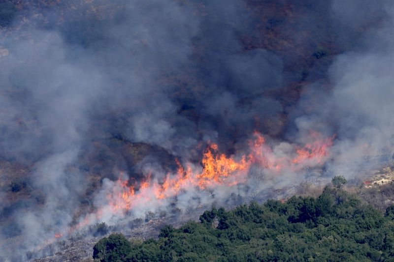 Flames and smoke rise from an Israeli airstrike on the Mahmoudieh mountain, as seen from Marjayoun town, south Lebanon, Tuesday, Sept. 24, 2024. (AP Photo/Hussein Malla)