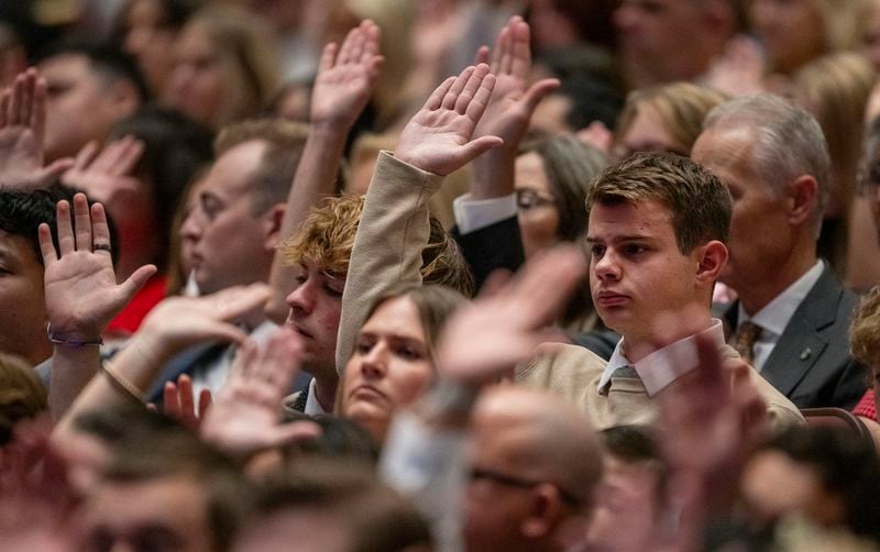 Conferencegoers participate in the sustaining of leadership of the church in the Conference Center in Salt Lake City during the 194th Semiannual General Conference of The Church of Jesus Christ of Latter-day Saints on Saturday, Oct. 5, 2024. (Scott G Winterton/The Deseret News via AP)