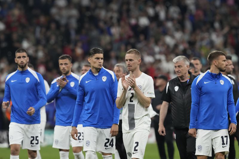 Slovenia's players react at the end of the penalties shootouts during a round of sixteen match at the Euro 2024 soccer tournament in Frankfurt, Germany, Monday, July 1, 2024. (AP Photo/Antonio Calanni)