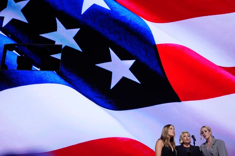 Emily Robison, from left, Natalie Maines and Martie Maguire, of The Chicks, sing the national anthem during the Democratic National Convention Thursday, Aug. 22, 2024, in Chicago. (AP Photo/Brynn Anderson)