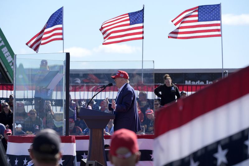 Republican presidential nominee former President Donald Trump speaks behind bullet-resistant glass during a campaign event at Central Wisconsin Airport, Saturday, Sept. 7, 2024, in Mosinee, Wis. (AP Photo/Alex Brandon)