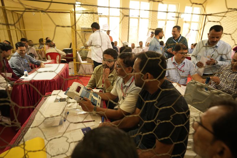 Election officers count votes for the recent election at a counting center in Jammu, India, Tuesday, Oct. 8, 2024. (AP Photo/Channi Anand)