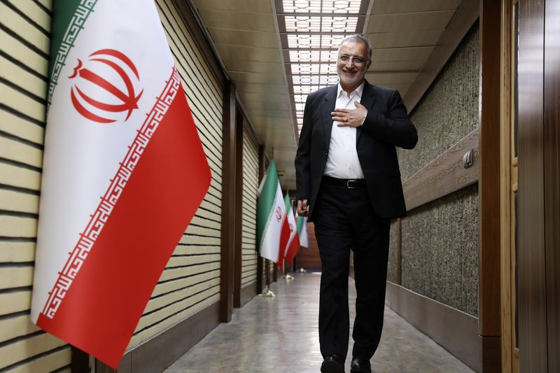 In this picture made available by Iranian state-run TV, IRIB, presidential candidate for the June 28, election Alireza Zakani, who is Tehran Mayor, arrives for a debate of the candidates at the TV studio in Tehran, Iran, Thursday, June 20, 2024. (Morteza Fakhri Nezhad/IRIB via AP)