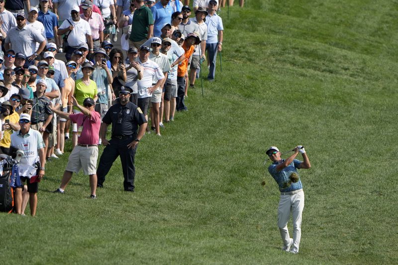 Rickie Fowler makes his approach shot on the first hole during the first round of the Travelers Championship golf tournament at TPC River Highlands, Thursday, June 20, 2024, in Cromwell, Conn. (AP Photo/Seth Wenig)