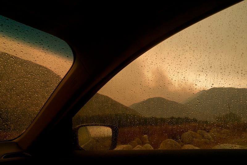 Smoke is seen from the advancing Line Fire through a car window in Mentone, Calif., Sunday, Sept. 8, 2024. (AP Photo/Eric Thayer)