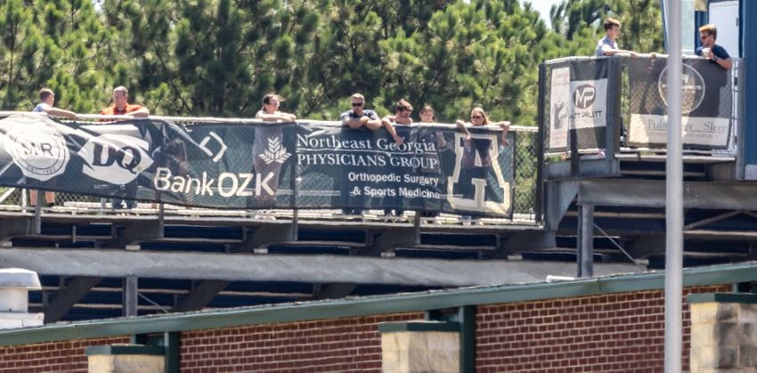 Students evacuated from Apalachee High to the school's football field watch the events on campus. Four people were killed and nine others were taken to various hospitals after a shooting at Apalachee High School in Barrow County, the GBI said Wednesday afternoon, Sept. 4, 2024. One person was in custody, the state agency confirmed. (John Spink/AJC)