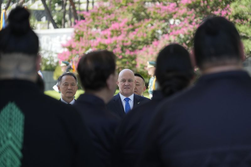 New Zealand's Prime Minister Christopher Luxon, enter, receives a haka waiata during a visit to National Cemetery in Seoul, South Korea, Wednesday, Sept. 4, 2024. (AP Photo/Ahn Young-joon)