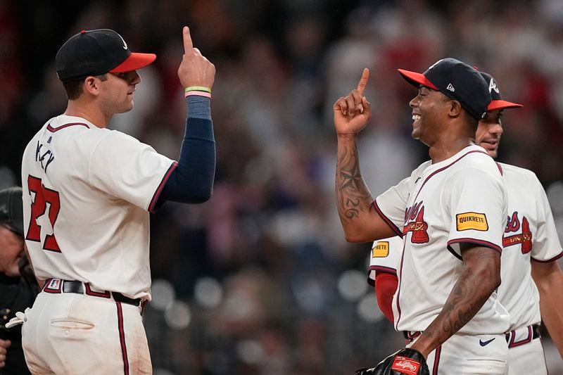 Atlanta Braves pitcher Raisel Iglesias (26) celebrates with Austin Riley (27) after a win against the San Francisco Giants, Wednesday, July 3, 2024, in Atlanta. (AP Photo/Brynn Anderson)