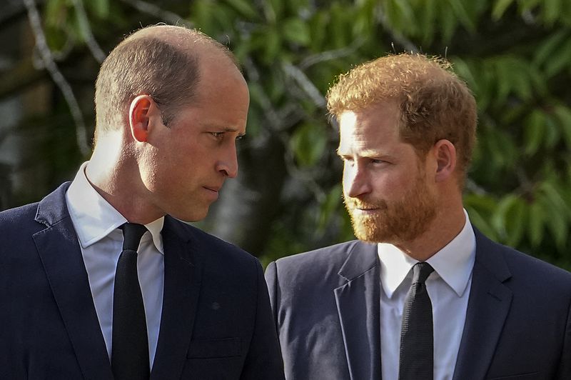 FILE - Britain's Prince William and Britain's Prince Harry walk beside each other after viewing the floral tributes for the late Queen Elizabeth II outside Windsor Castle, in Windsor, England on Sept. 10, 2022. (AP Photo/Martin Meissner, File)