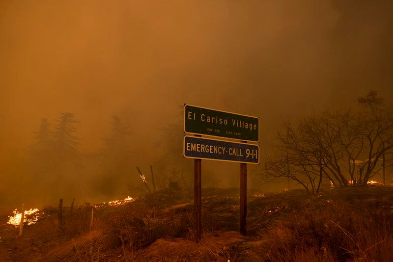 The Airport Fire surround a city limits sign Tuesday, Sept. 10, 2024, in El Cariso, an unincorporated community in Riverside County, Calif. (AP Photo/Etienne Laurent)