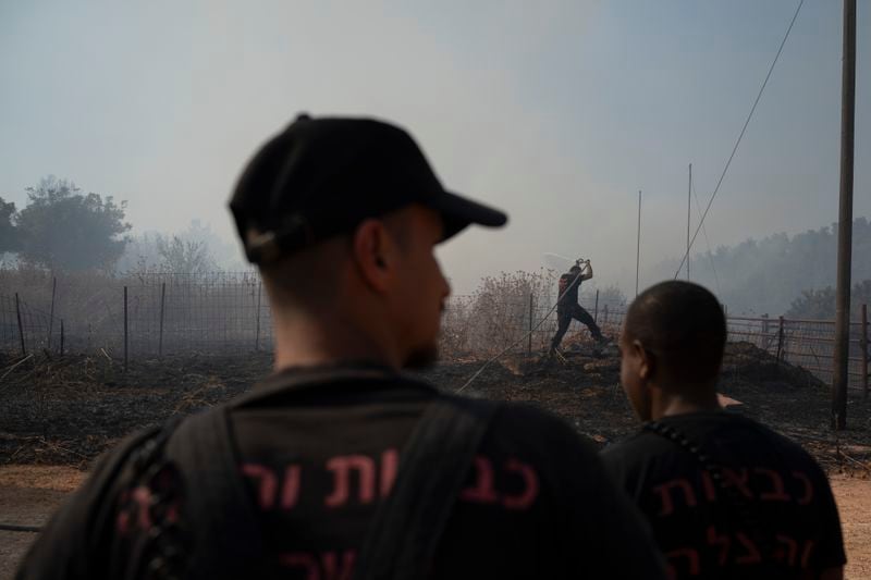 Israeli firefighters work to extinguish a fire burning in an area near the border with Lebanon, in Safed, northern Israel, Wednesday, June 12, 2024. Scores of rockets were fired from Lebanon toward northern Israel on Wednesday morning, hours after Israeli airstrikes killed four officials from the militant Hezbollah group including a senior military commander. (AP Photo/Leo Correa)