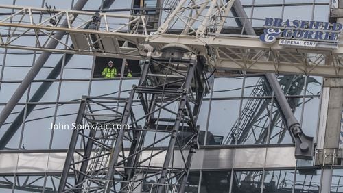 Several blocks of Midtown remain closed Saturday as construction crews work to dismantle a teetering crane outside a 31-story office tower.