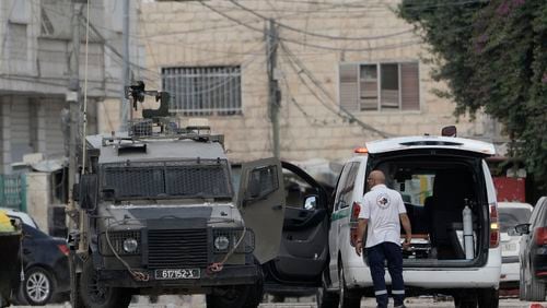 Members of the Israeli forces inside an armoured vehicle check an ambulance during a military operation in the West Bank city of Jenin, Wednesday, Aug. 28, 2024. (AP Photo/Majdi Mohammed)