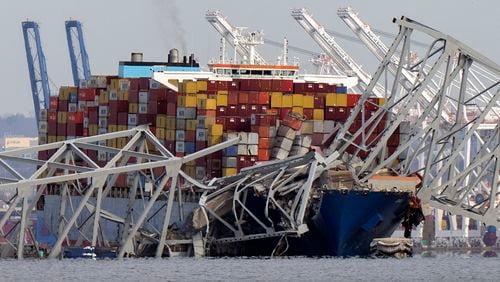 FILE - The cargo ship Dali is stuck under part of the structure of the Francis Scott Key Bridge after the ship hit the bridge, Tuesday, March 26, 2024, as seen from Pasadena, Md. (AP Photo/Mark Schiefelbein, File)