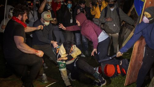 FILE - Demonstrators clash at an encampment at UCLA early Wednesday, May 1, 2024, in Los Angeles. The police chief at the University of California, Los Angeles, has been reassigned amid criticism of his handling of campus demonstrations. (AP Photo/Ethan Swope, File)