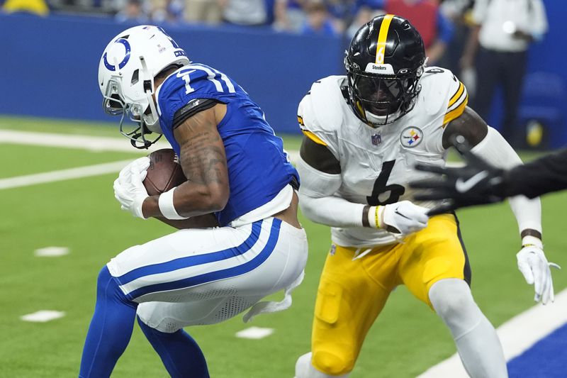 Indianapolis Colts wide receiver Josh Downs (1) backs into the end zone for a touchdown with Pittsburgh Steelers linebacker Patrick Queen (6) defending during the first half of an NFL football game Sunday, Sept. 29, 2024, in Indianapolis. (AP Photo/Darron Cummings)