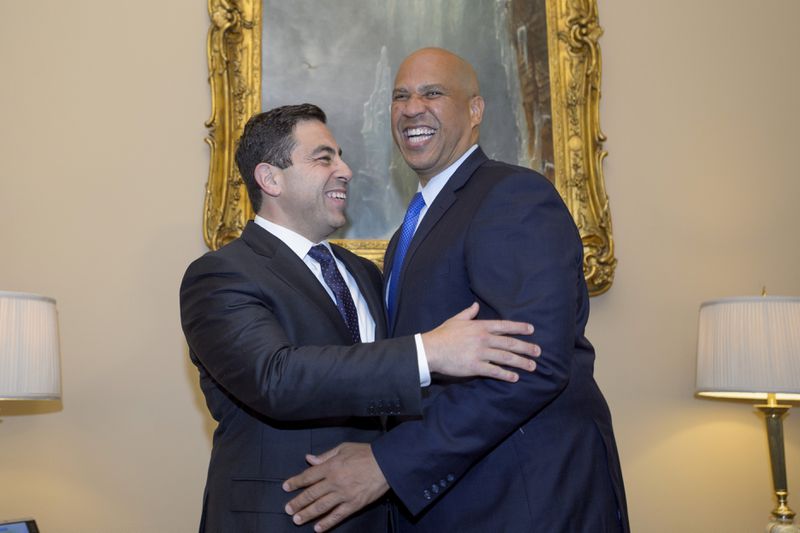 Senator-designee George Helmy, D-N.J., left, meets with Sen. Cory Booker, D-N.J., prior to taking the oath of office in the Old Senate Chamber at the Capitol in Washington, Monday, Sept. 9, 2024. (AP Photo/Rod Lamkey, Jr.)