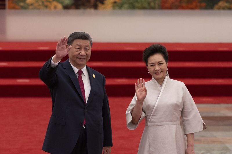 China's President Xi Jinping and his wife, Peng Liyuan, greet the press during a reception at the Forum on China-Africa Cooperation (FOCAC) in the Great Hall of the People in Beijing, China, Wednesday, Sept. 4, 2024. (Andres Martinez Casares/Pool via AP)