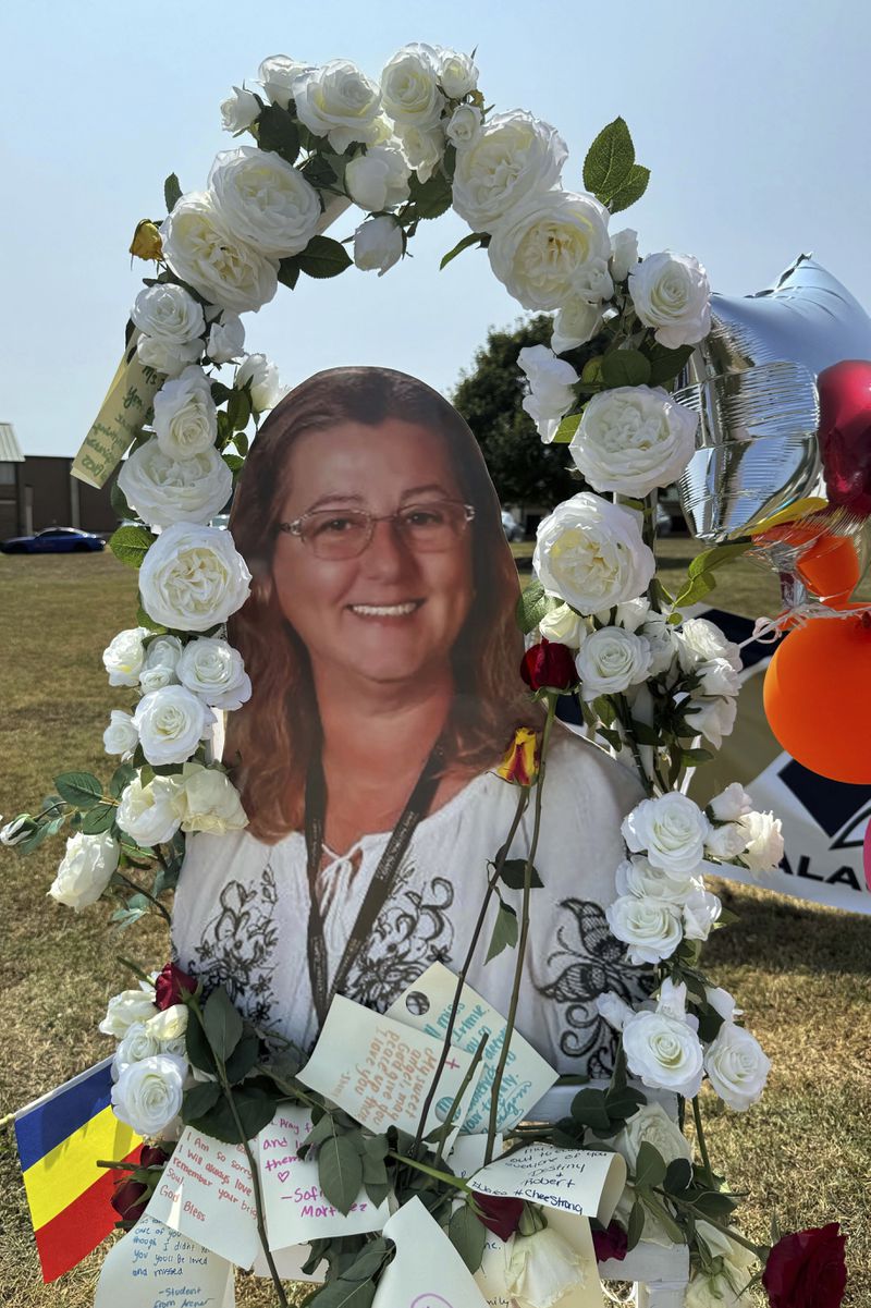 A poster with an image of shooting victim Cristina Irimie is displayed at a memorial outside Apalachee High School, Tuesday, Sept. 10, 2024, in Winder, Ga. (AP Photo/Charlotte Kramon)