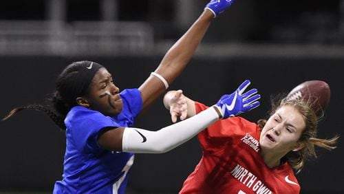 Peachtree Ridge’s Trinity Marshall, left, blocks North Gwinnett’s Sarah Kaufman’s pass during the finals of the flag football championships, Thursday, Dec. 20, 2018 at Mercedes Benz Stadium. North Gwinnett lost the game. (Annie Rice/AJC)