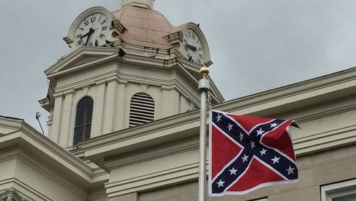 April 10, 2015: The Confederate battle flag flies outside the Chattooga County Courthouse in Summerville, Ga. The flag, which was flying on the 150th anniversary of the surrender of the Confederate forces at Appomatox, was put up with county approval by the local Sons of Confederate Veterans chapter. ROSALIND BENTLEY / rosalind.bentley@ajc.com