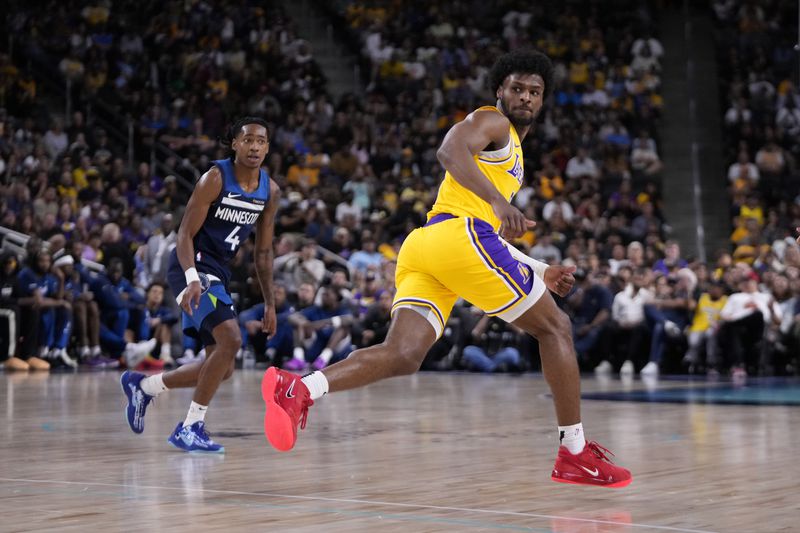 Los Angeles Lakers guard Bronny James, right, runs to the other end of the court as Minnesota Timberwolves guard Rob Dillingham watches during the first half of a preseason NBA basketball game, Friday, Oct. 4, 2024, in Palm Desert, Calif. (AP Photo/Mark J. Terrill)