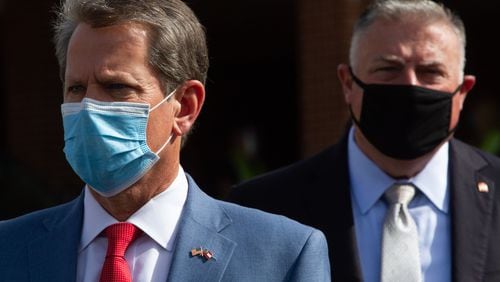 Gov. Brian Kemp, left, waits to talk with the press after touring a coronavirus testing site at Lilburn First Baptist Church in Gwinnett County on Friday, June 26, 2020. STEVE SCHAEFER FOR THE ATLANTA JOURNAL-CONSTITUTION