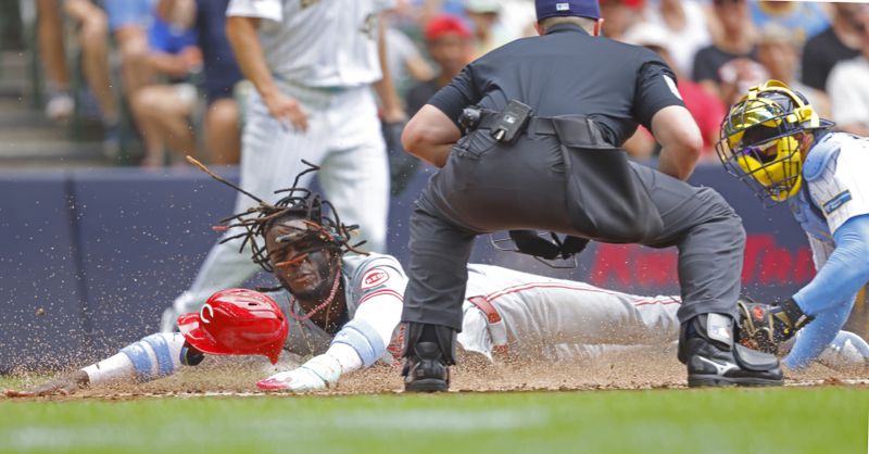 Cincinnati Reds' Elly De La Cruz scores ahead of the tag by Milwaukee Brewers' William Contreras during the third inning of a baseball game Sunday, June 16, 2024, in Milwaukee. (AP Photo/Jeffrey Phelps)