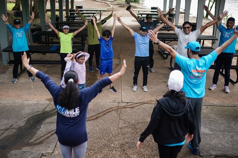 Members of the Atlanta Muslim Running Club stretch following a training run at Willeo Park in May. (Elijah Nouvelage for The Atlanta Journal-Constitution)