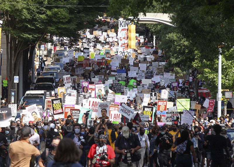 June 15, 2020 -  Atlanta - A crowd of demonstrators march to the Capitol.   The NAACP March to the Capitol coincided with the restart of the Georgia 2020 General Assembly.  Lawmakers returned wearing masks and followed new rules to restart the session during the pandemic.   Steve Schaefer for the Atlanta Journal Constitution