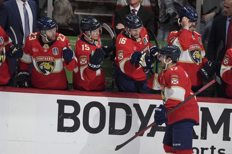 Florida Panthers center Evan Rodrigues (17) is congratulated by his teammates after scoring a goal during the second period of Game 5 of the NHL hockey Stanley Cup Finals against the Edmonton Oilers, Tuesday, June 18, 2024, in Sunrise, Fla. (AP Photo/Rebecca Blackwell)