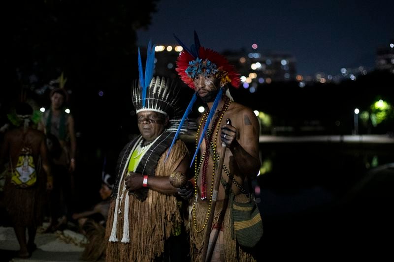 Indigenous people pose for a photo after a ceremony celebrating the return of the Indigenous Tupinamba people's sacred cloak to Brazil, in Rio de Janeiro, Thursday, Sept. 12, 2024. The garment, made from bird feathers and plant fibers, was repatriated to Brazil after having spent more than 300 years in the National Museum of Denmark. (AP Photo/Bruna Prado)