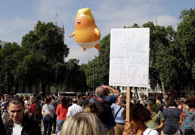 A 20-foot tall cartoon baby blimp of U.S. President Donald Trump is flown as a protest against his visit, in Parliament Square in London, England, Friday, July 13, 2018. Trump is making his first trip to Britain as president.