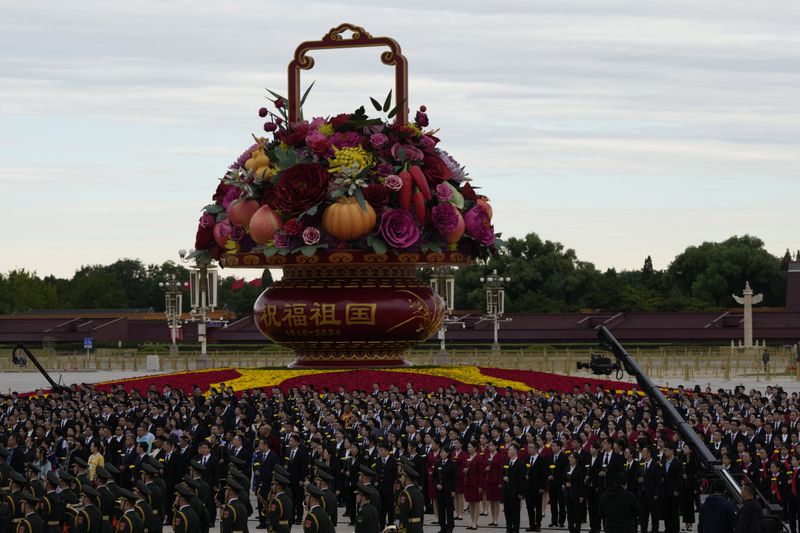 Attendees gather for a ceremony to mark Martyrs' Day ahead of the 75th anniversary of the founding of the People's Republic of China on Tiananmen Square in Beijing, Monday, Sept. 30, 2024. (AP Photo/Ng Han Guan)