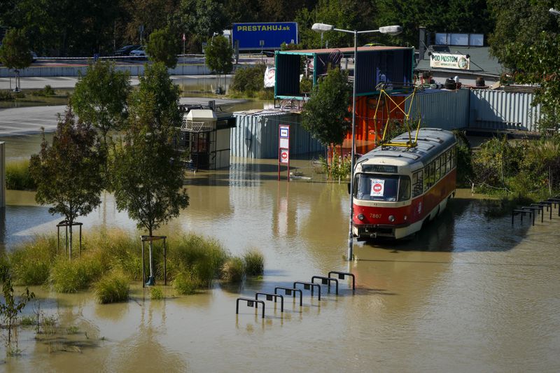 An old tram car is parked in flooded area near the Danube river in Bratislava, Slovakia, Wednesday, Sept. 18, 2024. (AP Photo/Darko Bandic)