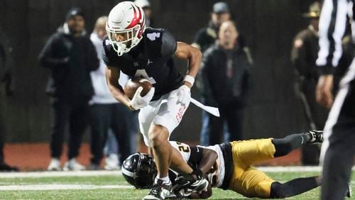 Milton wide receiver CJ Wiley (4) makes a catch against Colquitt County defensive back Alfonso McNeil (28) during the first half in the 7A quarterfinals at Milton High School Friday, November 24, 2023, in Milton, Ga. Milton won 39-37 to advance to the semi-finals. (Jason Getz / Jason.Getz@ajc.com)