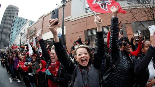 Buses carrying the Atlanta Falcons NFL football team are greeted by cheering fans during a send-off pep rally as they make their way to the airport for a flight to Houston and Super Bowl  LI, Sunday, Jan. 29, 2017, in Atlanta.