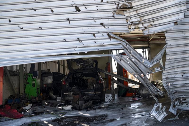 A damaged is seen inside a car repair shop that was hit by a rocket fired from Lebanon in Kiryat Shmona, northern Israel, Friday, Oct. 4, 2024. (AP Photo/Leo Correa)