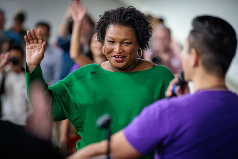 Democratic gubernatorial candidate Stacey Abrams makes her entrance at a campaign rally targeting Asian American and Pacific Islander (AAPI) voters in Norcross on Oct. 7, 2022. Her campaign has pulled back her TV ad spending recently. (Arvin Temkar/AJC)