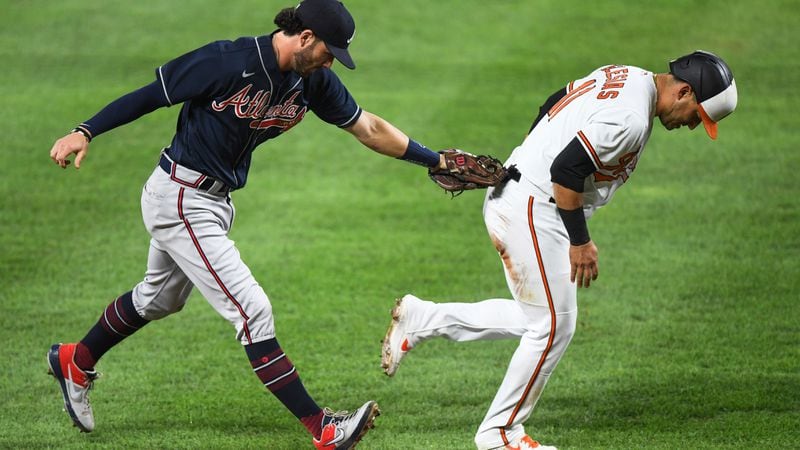 Orioles baserunner Jose Iglesias (11) is tagged out in a rundown by Braves shortstop Dansby Swanson in the first inning of Monday's game in Baltimore. (Terrance Williams/AP)