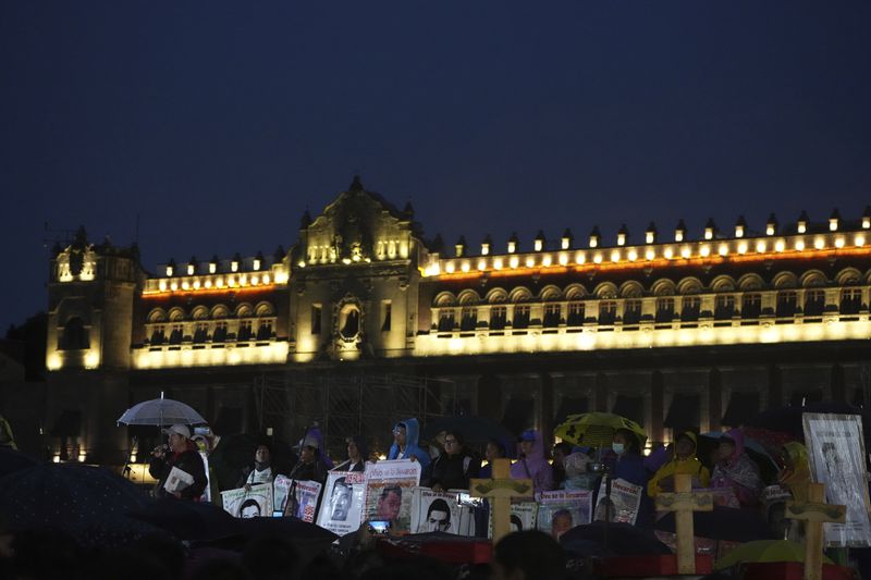 Families and friends gather outside the National Palace during a demonstration marking the 10-year anniversary of the disappearance of 43 students from an Ayotzinapa rural teacher's college, in Mexico City, Thursday, Sept. 26, 2024. (AP Photo/Fernando Llano)