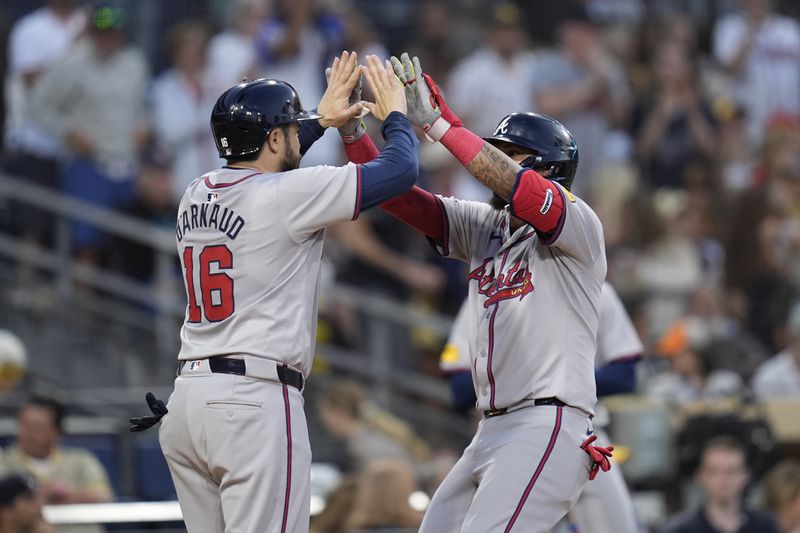 Atlanta Braves' Orlando Arcia, right, celebrates with teammate Travis d'Arnaud after hitting a two-run home run in the fifth inning of a baseball game against the San Diego Padres, Friday, July 12, 2024, in San Diego. (AP Photo/Gregory Bull)