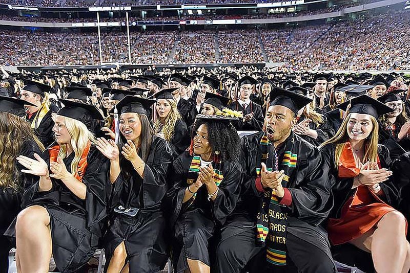 May 10, 2019 Athens - Students (from left) Isabella Skinner, Rinko Mitsunaga, Tiya Sutton, Cedrick Haney and Julia Solomon react before they move their tassels during UGA's 2019 spring undergraduate commencement ceremony at Sanford Stadium in Athens on Friday, May 10, 2019. HYOSUB SHIN / HSHIN@AJC.COM