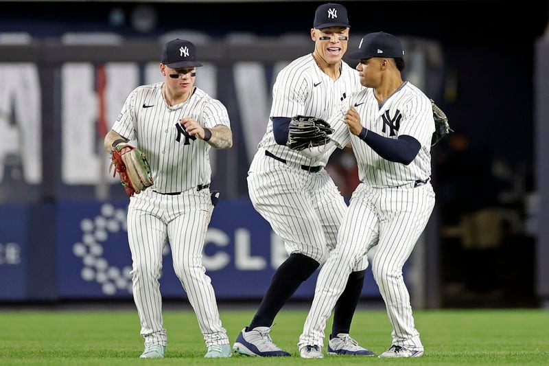 New York Yankees' Aaron Judge, center, Alex Verdugo, left, and Juan Soto, right, celebrate after a baseball game against the Boston Red Sox, Friday, Sept. 13, 2024, in New York. (AP Photo/Adam Hunger)