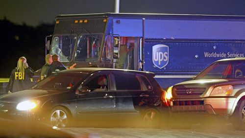 FILE - Law enforcement stand near a vehicle that appears to be part of the crime scene Thursday, Dec. 5, 2019, in Miramar, Fla. A Florida police union leader blasted prosecutors Monday, July 29, 2024, for charging four officers with the 2019 shootout with two robbers that left a hijacked UPS driver and a passerby dead, saying they had no choice but to return fire on a busy suburban street. (Charles Trainor Jr./Miami Herald via AP, File)